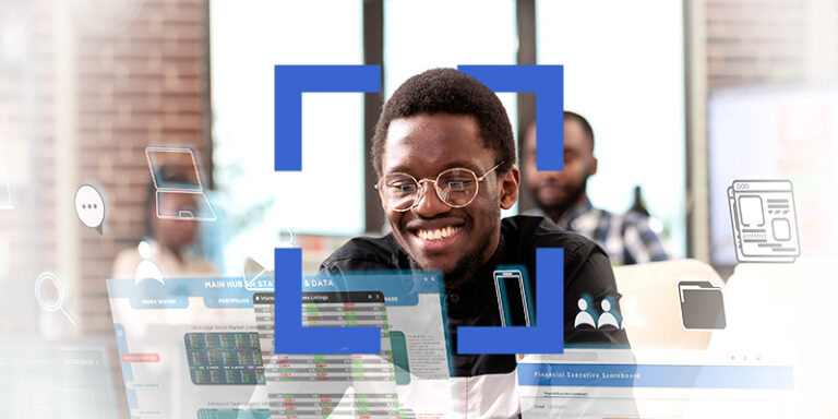 Smiling Black man with glasses at a desk, surrounded by translucent dashboards and icons in a collaborative office environment