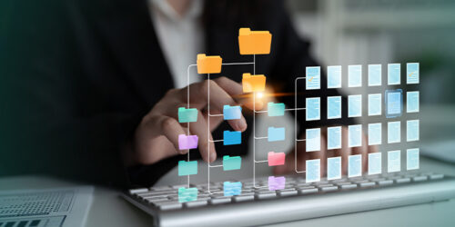Businessperson uses a holographic folder-and-document workflow projected above a keyboard while organizing files.