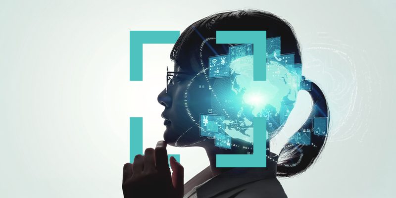 Side profile of a woman wearing a headset with holographic blue data screens around her, symbolizing AI support or telecommunication.